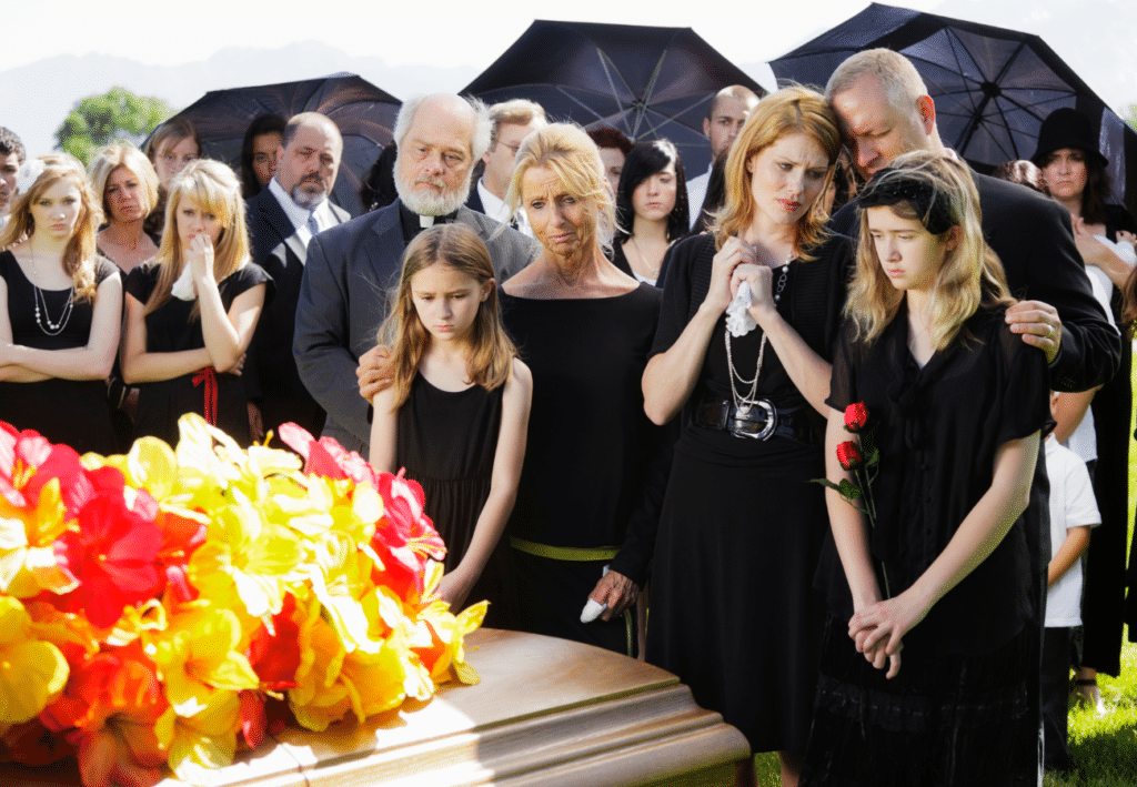 Image of a group of people at a funeral on Tegeler's website