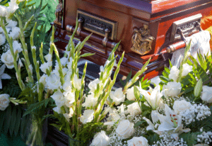 Image of a casket surrounded by flowers